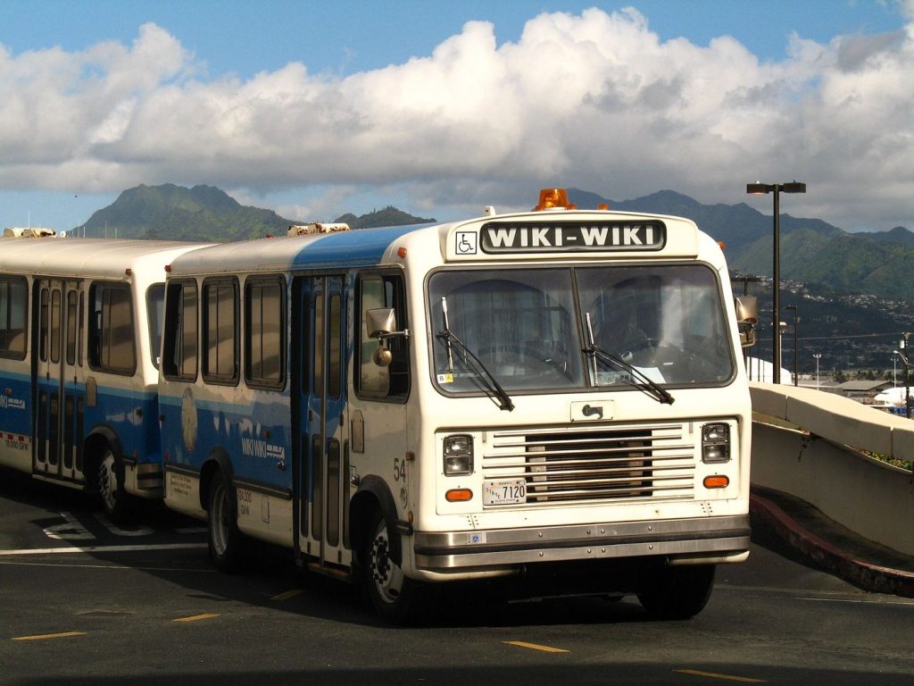 airport shuttle bus waiting outside a terminal